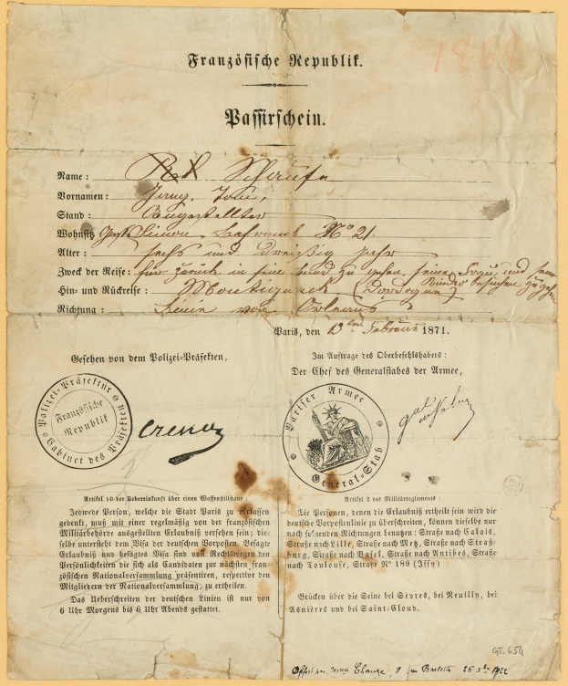 Ein altes, vergilbtes Dokument mit einem kreisförmigen, schwarz umrandeten Stempel, das schwarze Tintenbuchstaben enthält, wahrscheinlich ein Schreiben der Deutschen Regierung.