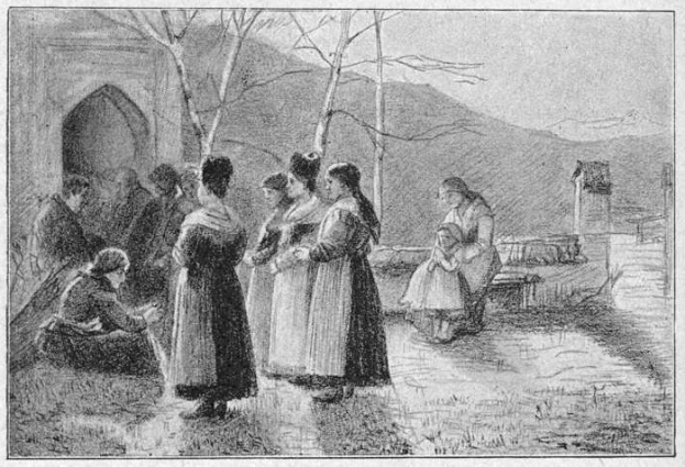 Schwarzes und weißes Foto einer Gruppe von Menschen, die vor einem Gebäude mit B├Ąumen, Hügeln und einem klaren Himmel stehen, mit dem Text "Victorian Women's Suffrage" unten.